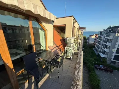 a balcony with chairs and a table on a building at Home by the Sea in Burgas City