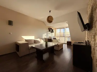 a living room with a couch and a table at Home by the Sea in Burgas City