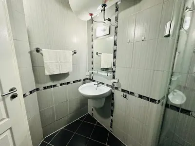 a small bathroom with a sink and a toilet at Blue Marine - Daneli Apartment in Sunny Beach