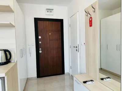 a hallway with a wooden door in a room at HORIZON 38 'Б' Studio Sveti Vlas in Sveti Vlas