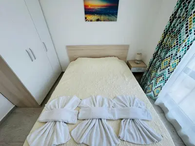 a bedroom with a bed with two pillows on it at HORIZON 34 'Б-' Apartment Sveti Vlas in Sveti Vlas