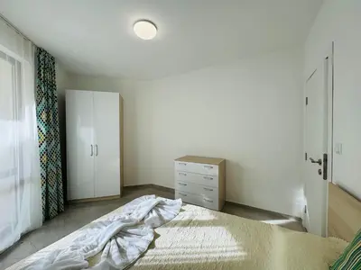 a bedroom with a bed and a dresser at HORIZON 34 'Б-' Apartment Sveti Vlas in Sveti Vlas