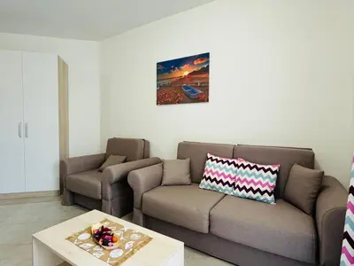 a living room with a couch and a table at HORIZON 26 'Б' Apartment Sveti Vlas in Sveti Vlas