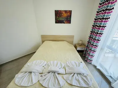 a bedroom with a bed with two pillows on it at HORIZON 26 'Б' Apartment Sveti Vlas in Sveti Vlas