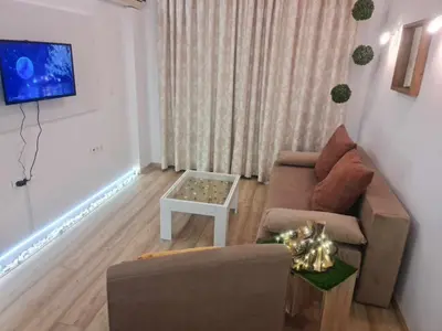 a living room with a couch and a table at Aglaya 2 - Pomorie Bay in Pomorie