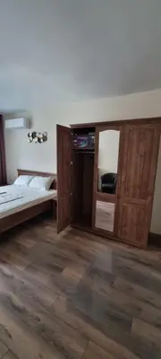 a room with a bed and a mirror in it at Central Luxe Apartament Mimoza in Varna City