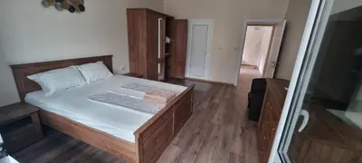 a small bedroom with a bed and a glass door at Central Luxe Apartament Mimoza in Varna City