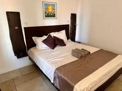 a bed with two pillows on it in a bedroom at Arthotel Oscar II Sozopol in Sozopol
