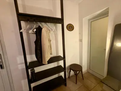 a room with a closet with a shelf and a stool at Arthotel Oscar II Sozopol in Sozopol