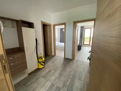an empty room with a door and a room with a hallway at Vineyards Resort - Apartment Panorama in Kableshkovo