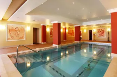 a large swimming pool in a hotel lobby at Vineyards Resort - Apartment Panorama in Kableshkovo