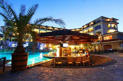 a restaurant with a table in front of a building at Vineyards Resort - Apartment Panorama in Kableshkovo