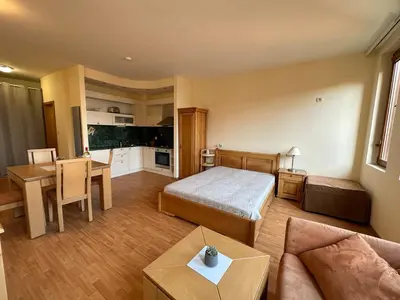 a bedroom with a bed and a living room at Studio in Garden of Eden D402 - Sveti Vlas, Bułgaria in Sveti Vlas