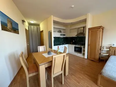 a kitchen and dining room with a table and chairs at Studio in Garden of Eden D402 - Sveti Vlas, Bułgaria in Sveti Vlas