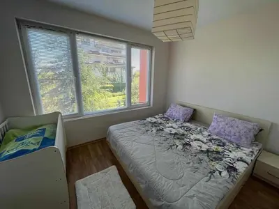 a bedroom with a bed with flowers on it at Oasis2 in Nesebar