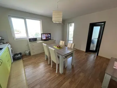a kitchen and dining room with a table and chairs at Oasis2 in Nesebar
