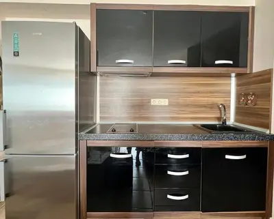 a kitchen with a stainless steel refrigerator and a sink at Prestige Fort Sveti Vlas Aparthotel 1 bedroom 4 people in Sveti Vlas