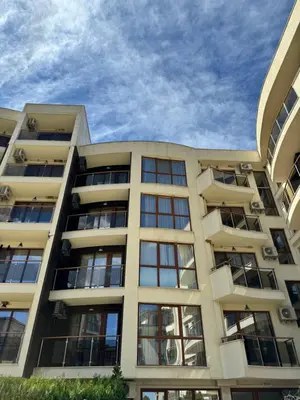 a large apartment building with a sky in the background at Sunshine apartment in Shkorpilovtsi