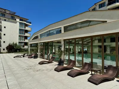 a row of chairs in front of a building at Sunshine apartment in Shkorpilovtsi