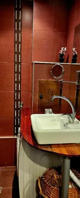 a bathroom with a sink and a red wall at Апартамент ЛазуР in Burgas City