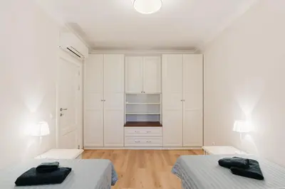 two beds in a white room with white cabinets at Sozopol Созопол MORE SUN 2 Б Sozopolis in Sozopol
