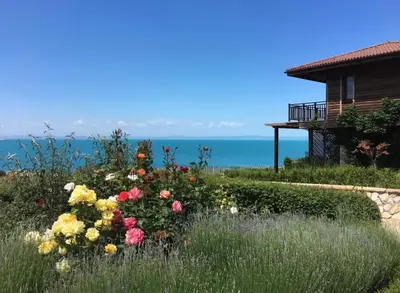 a garden with flowers in front of a house at Sozopol Созопол MORE SUN 2 Б Sozopolis in Sozopol