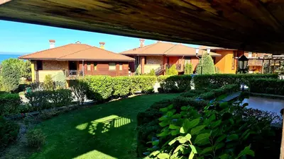 a backyard with a house and a yard with a pond at Sozopol Созопол MORE SUN 2 Б Sozopolis in Sozopol