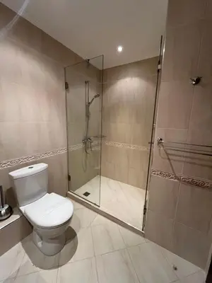 a bathroom with a toilet and a shower at Двуспални апартаменти Оазис Бийч клуб in Lozenets