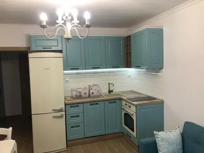 a kitchen with blue cabinets and a white refrigerator at Brandnew 3 Room Apartment with Poolview in Cascadas Resort in Sunny Beach
