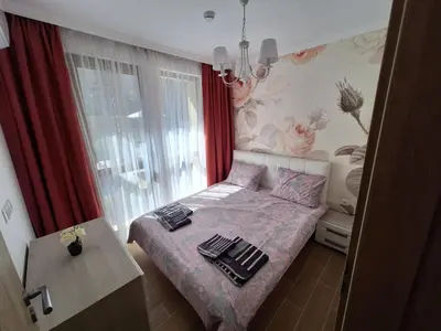 a small bedroom with a bed and a window at Brandnew 3 Room Apartment with Poolview in Cascadas Resort in Sunny Beach