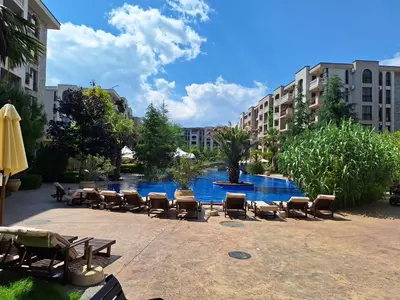 a resort with a pool and chairs and buildings at Brandnew 3 Room Apartment with Poolview in Cascadas Resort in Sunny Beach