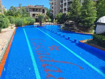 an empty swimming pool with blue water at Brandnew 3 Room Apartment with Poolview in Cascadas Resort in Sunny Beach