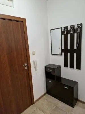 a room with a door and a dresser and a mirror at Дом Крумови in Burgas City