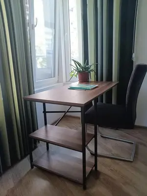 a wooden table and a chair with a plant on it at Дом Крумови in Burgas City