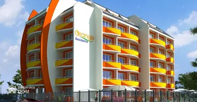 a building with an orange and white building at Студия в центре Солнечного берега in Sunny Beach