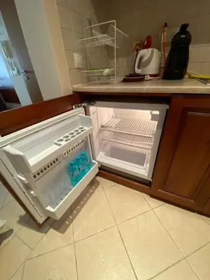 an empty refrigerator with its door open in a kitchen at Sozopol Santa Marina Sea View Studio in Sozopol