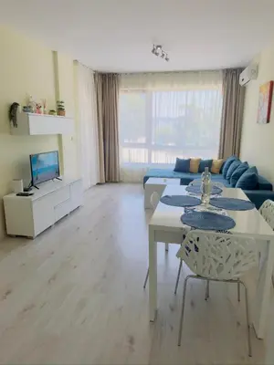 a living room with a couch and a table at Seaside View Apartment in Varna in Varna City