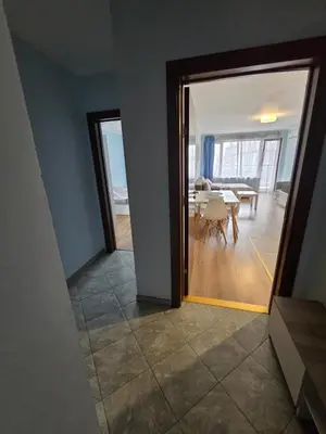 a view of a dining room and a living room with a table at Апартамент ЛаХабана до плажа в Поморие in Pomorie