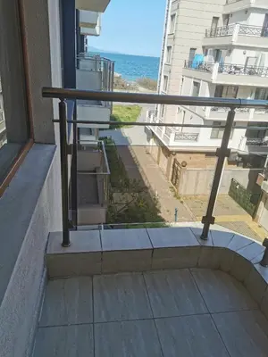 a balcony with a view of the ocean at Апартамент ЛаХабана до плажа в Поморие in Pomorie
