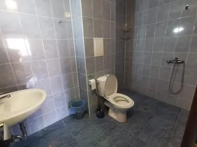 a bathroom with a toilet and a sink at Апартамент ЛаХабана до плажа в Поморие in Pomorie