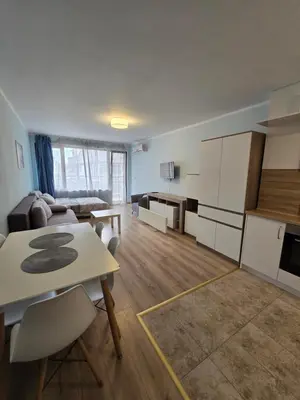 a kitchen and living room with a table and chairs at Апартамент ЛаХабана до плажа в Поморие in Pomorie
