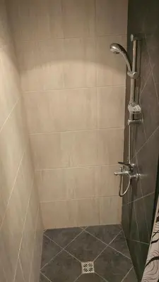 a bathroom with a shower with a glass door at Sea and Sand Apartment in Sozopol