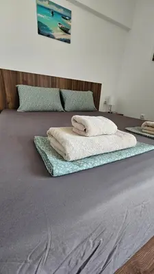 two towels sitting on top of a bed at Sea and Sand Apartment in Sozopol