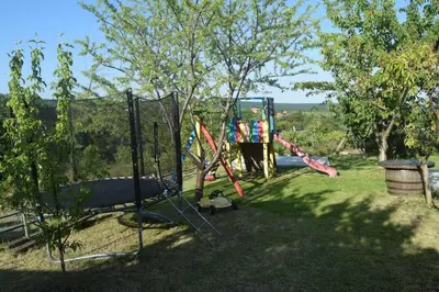 a group of playground equipment in the grass at Къща Виктория in Banya