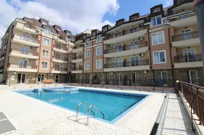 a swimming pool in front of a building at Horizont - Menada Apartments in Sunny Beach