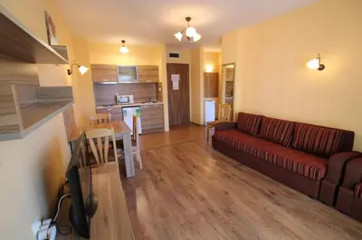 a living room with a couch and a table and a kitchen at Horizont - Menada Apartments in Sunny Beach