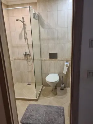 a bathroom with a shower and a toilet at Sunrise Luxury Sauth Bay in Varna City