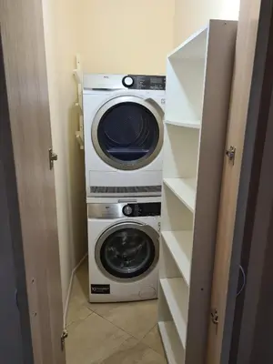 a washer and a washing machine in a closet at Sunrise Luxury Sauth Bay in Varna City