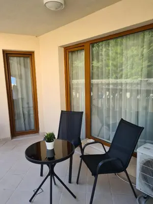 a room with a table and chairs and windows at Sunrise Luxury Sauth Bay in Varna City