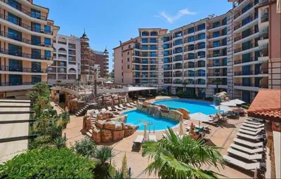 a resort with a swimming pool and some buildings at Апартаменты с одной спальней Carolina in Sunny Beach